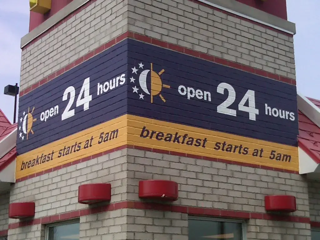 Exterior 24 Hours building band signage installed at a McDonald's by Performance Graphics